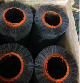 picture of four wide face abrasive bristle brush tubes for cleaning and finishing metal strip in a crate being built for shipping