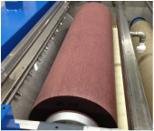 Picture of non-woven abrasive brush in brush machine for cleaning aluminum large parts for aerospace industry