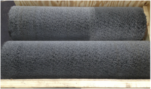 picture of two wide face abrasive bristle brush tubes for cleaning and finishing metal strip in a crate