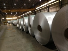 Picture of cleaned and brushed steel strip coils in a steel mill waiting to be shipped