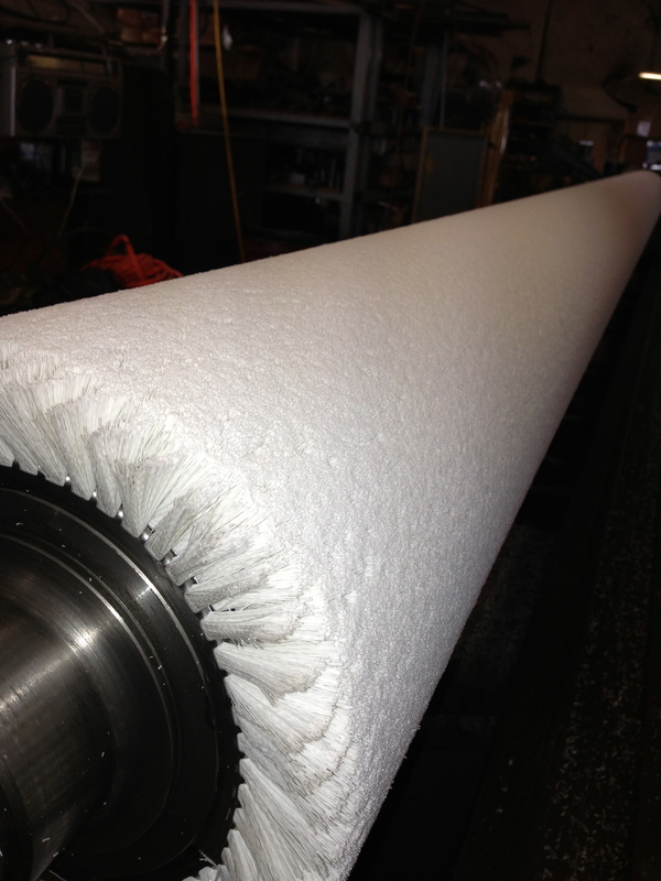 Picture of a wide face non-abrasive bristle brush being trimmed in our manufacturing facility