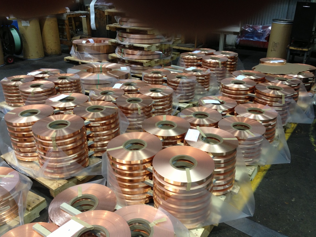 Picture of narrow metal copper strip coils for processing in copper mill