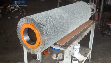 picture of wide face abrasive and non-abrasive bristle brush tube for cleaning and finishing metal strip and sheet in a APT narrow strip cleaning brush machine for copper, steel, stainless steel, aluminum, titanium, and other special alloys strip