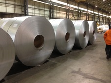 Picture of stainless steel coils in a steel mill waiting to be processed