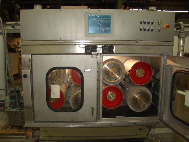 Picture of wide face abrasive bristle brushes in a flat metal strip brush machine for cleaning and finishing narrow strip metal with abrasive and/or non-abrasive brushes to clean copper, steel, stainless steel, aluminum, titanium, and other special alloys