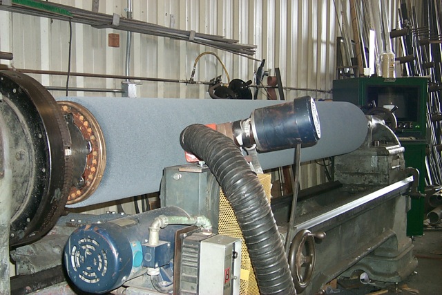 Picture of wide face abrasive bristle brush in APT manufacturing factory being trimmed and then dynamically balanced